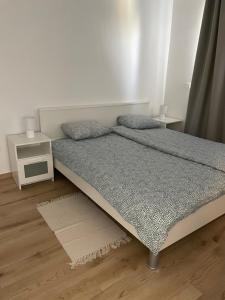 a bedroom with a bed and a night stand at Apartman ‘Marko’ in Kutina