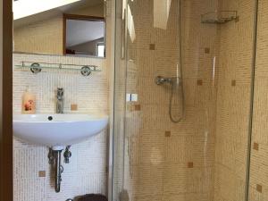a bathroom with a sink and a shower at Drávecz Apartman in Balatonlelle +27 photos