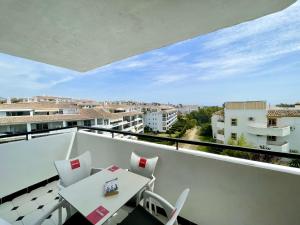 a balcony with a white table and chairs at Rincon del Mar Spacios 3 bedrooms apartment close to Calahonda Beach - Mijas Costa in Mijas Costa