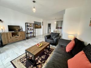 a living room with a couch and a table at Rincon del Mar Spacios 3 bedrooms apartment close to Calahonda Beach - Mijas Costa in Mijas Costa
