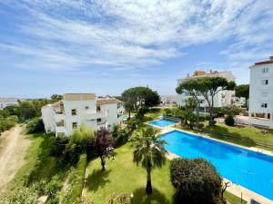 an apartment with a swimming pool and a building at Rincon del Mar Spacios 3 bedrooms apartment close to Calahonda Beach - Mijas Costa in Mijas Costa