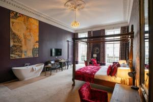 a bedroom with a bed and a tub and a sink at No11 Boutique Hotel & Brasserie in Edinburgh