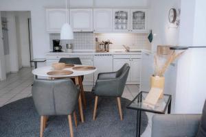 a kitchen with a table and chairs in a room at Haus Sandröschen in Norderney