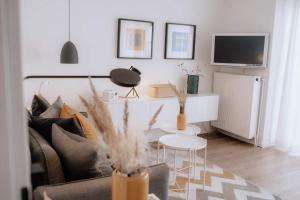 a living room with a couch and a table at Haus Sandröschen in Norderney