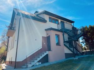 a house with stairs on the side of it at Zakątek Solny in Bochnia