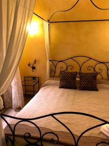 a bedroom with a bed with a wrought iron headboard at Ca Bea in Venice