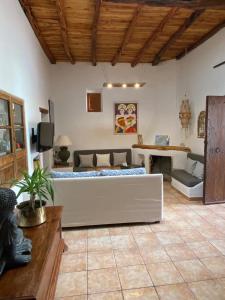 a living room with a couch and a table at Casa Can Coves in Santa Gertrudis de Fruitera