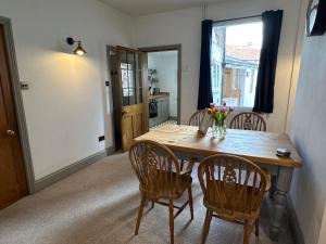 a dining room with a wooden table and chairs at Quayside Georgian Townhouse in Kings Lynn