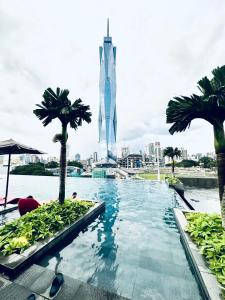 a swimming pool with a view of the burj khalifa at Millennium Suite At Opus Residence in Kuala Lumpur