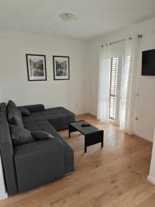 a living room with a couch and a table at Two person apartment in Nin