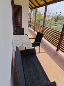 a patio with a table and chairs on a balcony at Two person apartment in Nin