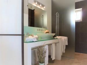 a bathroom with a sink and a mirror at Superb air-conditioned house with heated pool in Gordes - by feelluxuryholydays in Gordes
