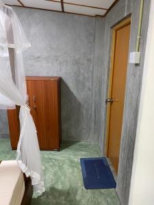 a small room with a bed and a blue mat at Shek villa in Hikkaduwa