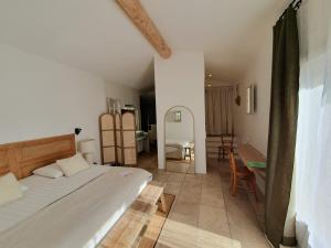 a bedroom with a bed and a living room at Superb air-conditioned house with heated pool in Gordes - by feelluxuryholydays in Gordes