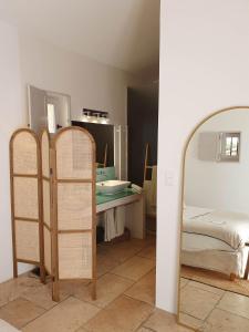 a room with a bed and a mirror at Superb air-conditioned house with heated pool in Gordes - by feelluxuryholydays in Gordes