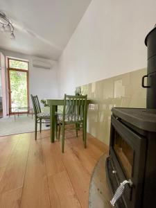 a dining room with a green table and chairs at Kaunas Green in Kaunas