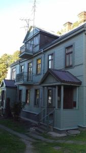 a large blue house with a balcony on top of it at Kaunas Green in Kaunas