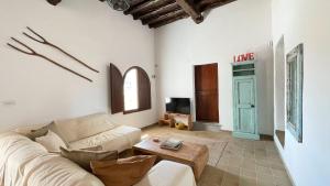 a living room with a couch and a table at Finca Can Toni den Real in Sant Josep de sa Talaia
