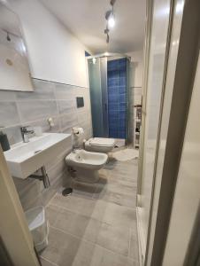 a bathroom with a white toilet and a sink at Casa Eden in Atrani