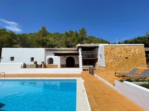 a villa with a swimming pool and a house at Finca Can Toni den Real in Sant Josep de sa Talaia