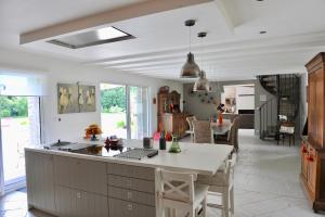 a kitchen with a large island in a room at LE CLOS DE LA HOURSERIE in Pornic