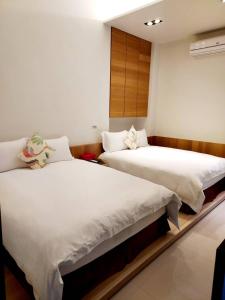 Voodi või voodid majutusasutuse 野居海景渡假民宿Simple Life Home Stay toas