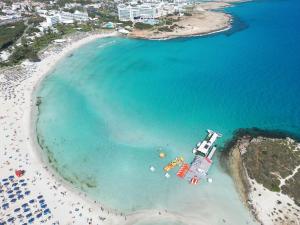 an aerial view of a beach with a cruise ship at Aktea Beach Village in Ayia Napa
