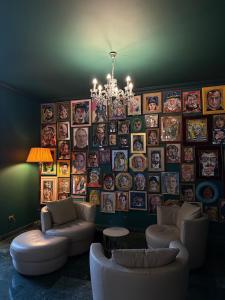 a living room with couches and a large wall of pictures at Hotel Atlantico in Castiglioncello