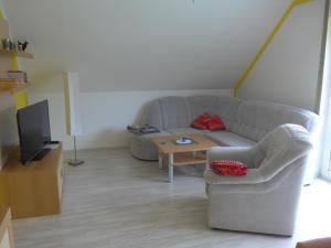 a living room with a couch and a table at Ferienwohnung Ulbrich in Bautzen