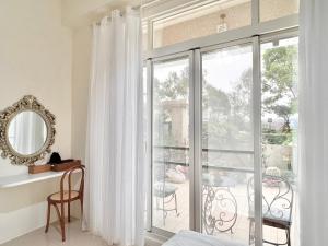 a bedroom with a large window with a view of a patio at 永安101 Wing on x 附陽台 in Taitung City