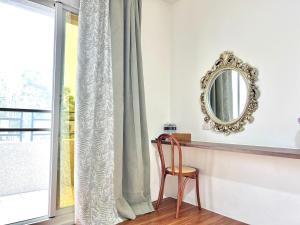 a chair sitting in front of a window with a mirror at 永安101 Wing on x 附陽台 in Taitung City