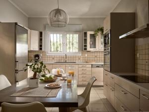 a kitchen with a table with a bowl of fruit on it at Villa Anatoli - Tranquil Escape with Scenic Views, by ZanteWize in Akrotiri