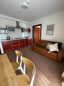 a living room with a couch and a table at Villa Baltic Apartament nr 3 in Chałupy