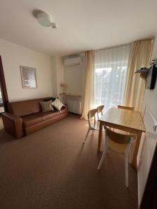 a living room with a couch and a table at Villa Baltic Apartament nr 3 in Chałupy