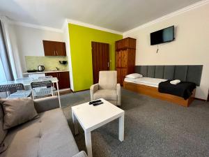 a hotel room with a bed and a living room at Gościniec Rospuda in Augustów