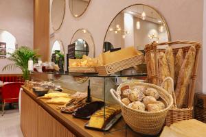 a bakery with bread and pastries on a counter at Ari Boutique Hôtel - Adult Only in Marrakech