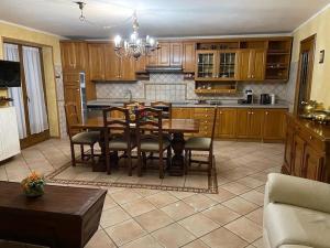 a kitchen with a table and chairs in a room at La Villetta di Oulx in Oulx