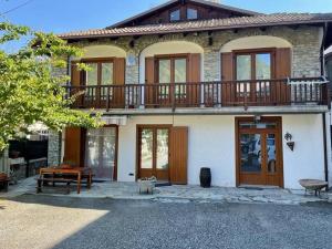a house with a balcony on top of it at La Villetta di Oulx in Oulx