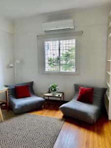 a living room with two couches and a window at Depto de lujo frente al Botánico in Buenos Aires