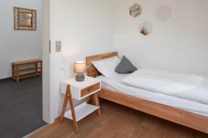 um quarto com uma cama e um candeeiro numa mesa de cabeceira em ⸨⸩ Sunset Penthouse: Messe - Siemens - DB - MAN ⸨⸩ em Nurembergue