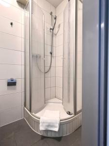 a bathroom with a shower with a towel at Burghotel Lörrach in Lörrach