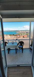 a balcony with a table and a view of the ocean at Vista Capodistria in Koper