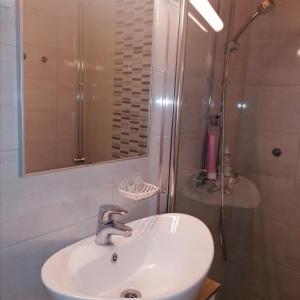 a bathroom with a white sink and a shower at Kolmio Väinöläntie 6 in Lieksa +14 photos