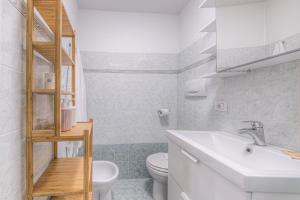 a white bathroom with a sink and a toilet at Oro by PortofinoHomes in Rapallo