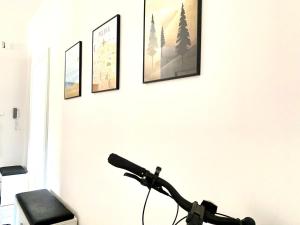 a microphone on a white wall with four pictures at Nad Młynówką in Opole
