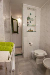 a bathroom with a toilet and a shower and a sink at Casa Pein in Carloforte
