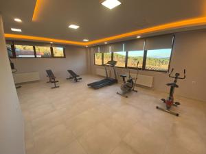 a gym with treadmills and exercise bikes in a room at La Vie En Rose Hotel by Sogutdagi Isparta in Keçiborlu