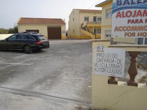 a car parked in a parking lot next to a building at Baleal Sol Alojamentos in Baleal