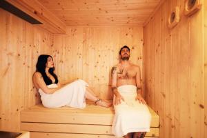 a man and woman sitting in a sauna at La Corte Di Ambra in Cortona
