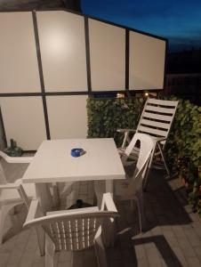 a white picnic table and two chairs on a patio at B&b Cleopatra in Scalea +37 photos